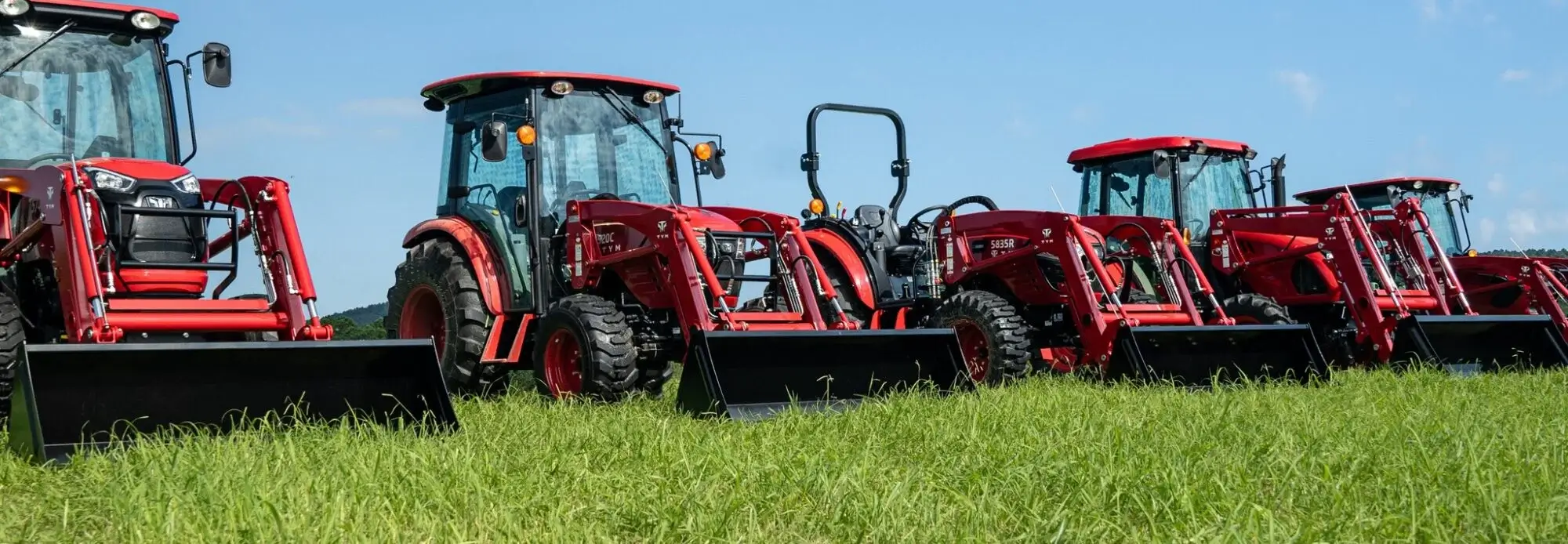 Red tractors in a field